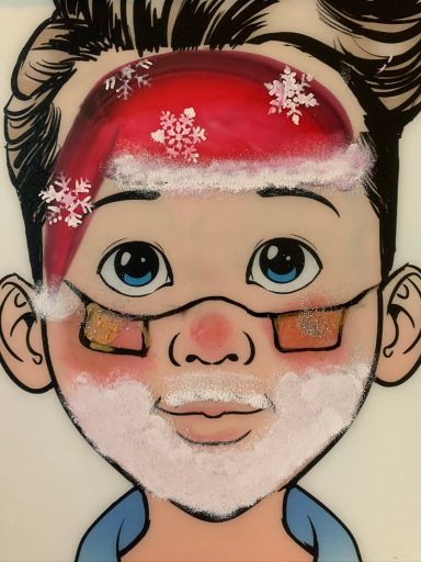 Junge mit rotem Weihnachtsmütze, Schneemann-Gesicht und Brille, fröhlicher Ausdruck.